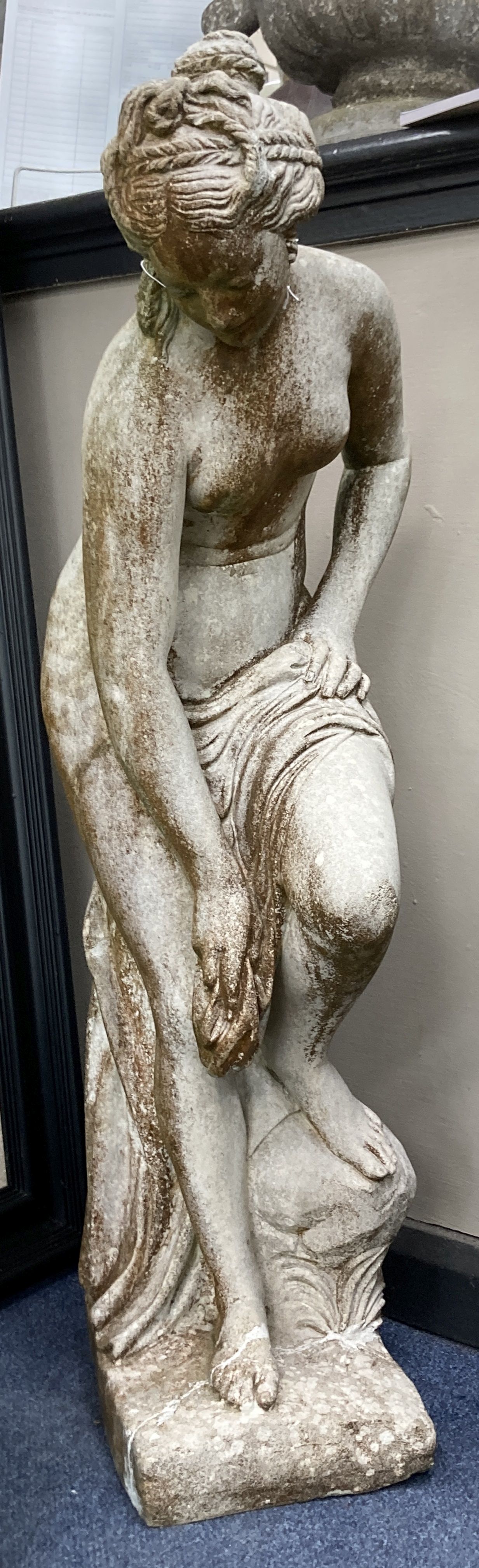 A reconstituted stone garden ornament of a female bather, 86cm high